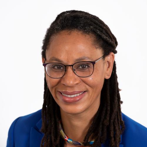 Head shot photograph of Andrea Armstrong. Black woman with medium length black hair wearing glasses and a blue blazer. HeadstrongAndreaArmstrong