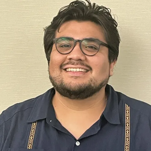 Latino man smiling with glasses