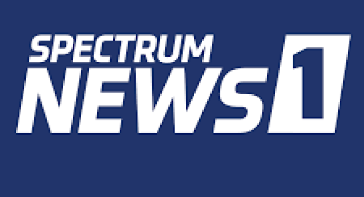 Image of Spectrum News 1 logo. White letters on navy blue background.