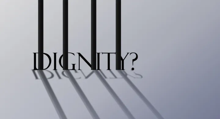 Image of bars with the word Dignity? behind them