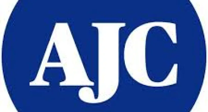 A J C white letters on circular blue background