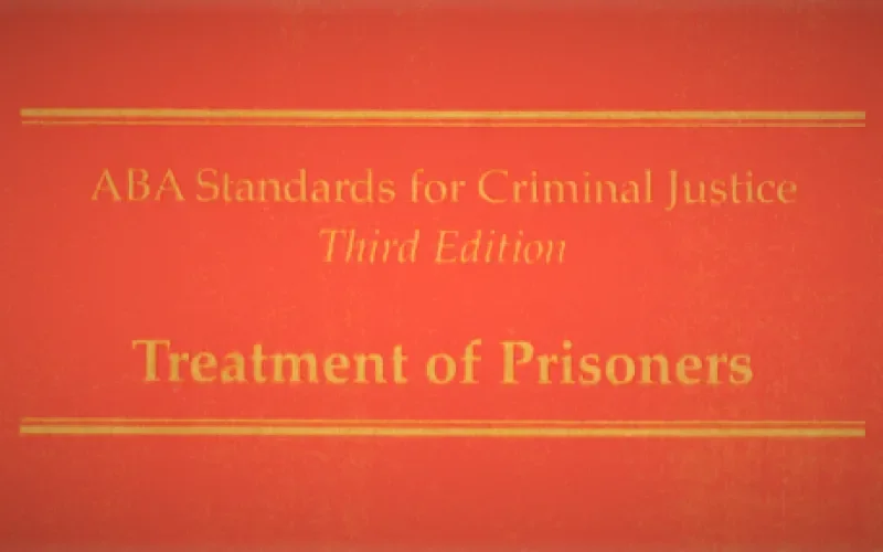 Photo of the ABA Standards for Criminal Justice. Gold text on red background.
