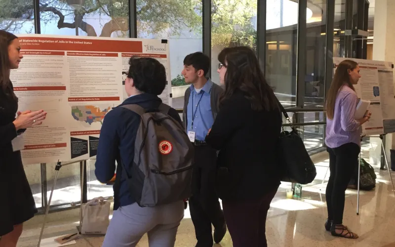 Photo of students in front of a white board presentation.