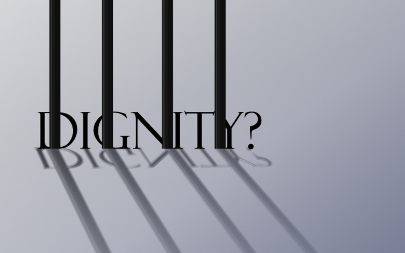 Image of bars with the word Dignity? behind them