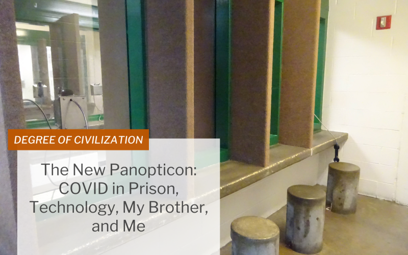 Image of a non-contact visit room in a jail, showing a telephone hanging from a glass window.